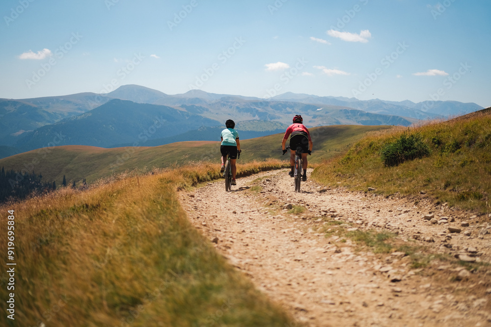 Gravel bikers on Transalpina strategic road in the Carpathian Mountains in Romania. Gravel bikers on Transalpina strategic road in the Carpathian Mountains in Romania.