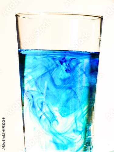 close- up abstract image showing a glass with water and methylene blue. photo