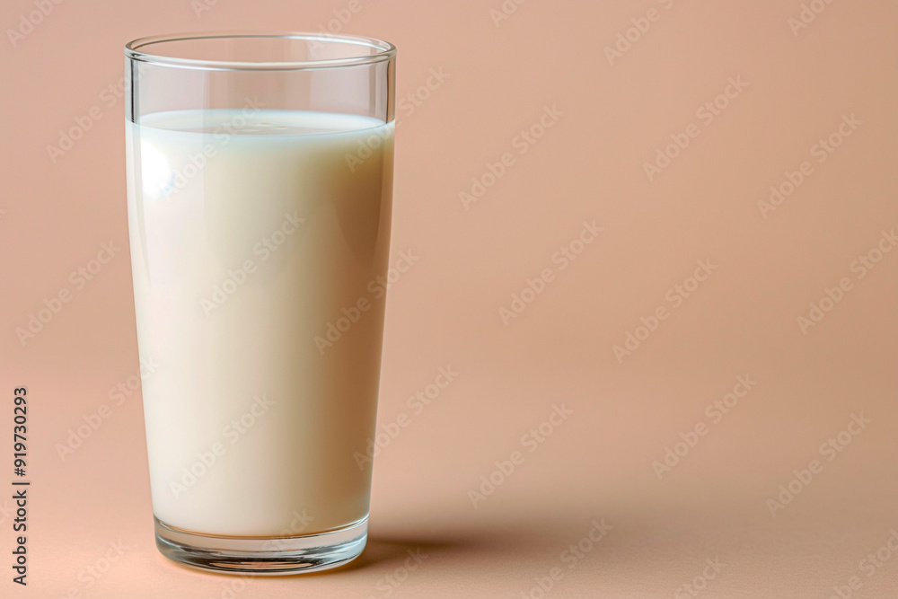 a glass of milk on an orange background a glass of milk on an orange background