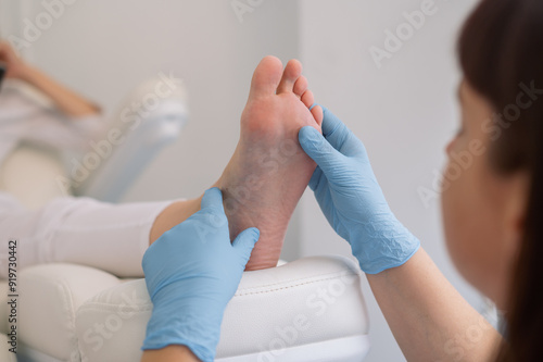 The podologist examine the feet. Patient on medical pedicure procedure, visiting podiatrist. Peeling feet. Foot treatment in SPA salon.Podiatry clinic