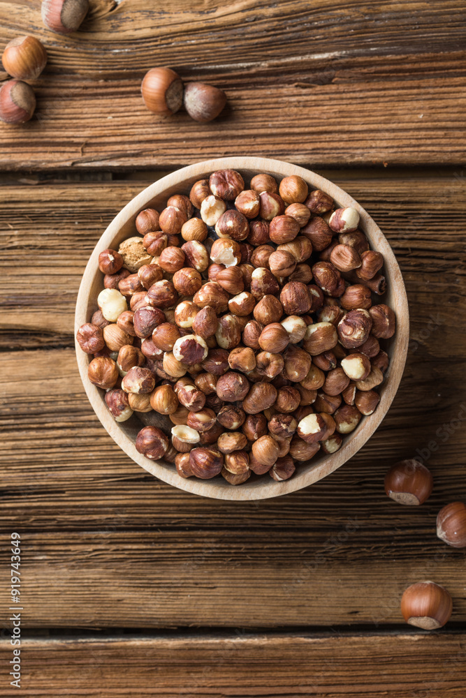 Full and peeled hazelnuts close-up. Macro photo of pile of filbert kernels Full and peeled hazelnuts close-up. Macro photo of pile of filbert kernels