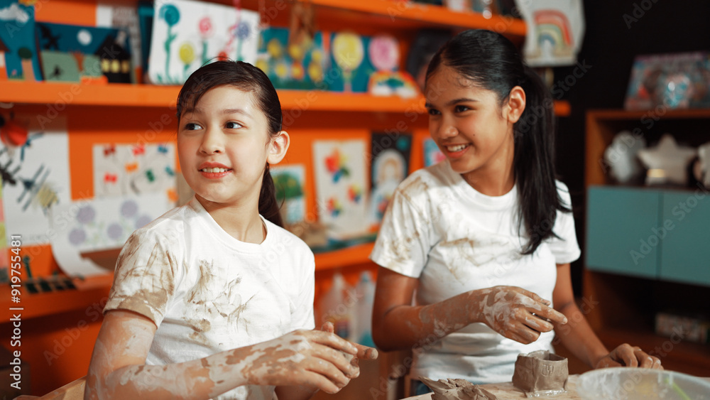 Diverse highschool student modeling cup of clay while wearing dirty shirt at art lesson. Multicultural student working or making dough art in creative activity. Blurring background.. Edification. Diverse highschool student modeling cup of clay while wearing dirty shirt at art lesson. Multicultural student working or making dough art in creative activity. Blurring background.. Edification.
