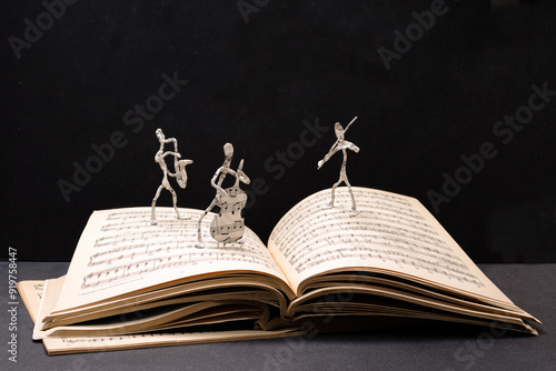 figurines of jazz musicians on the pages of a music notebook, copy space photo