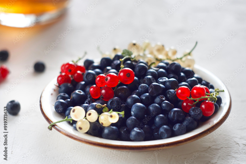 Blueberries and lingonberries in a plate on the table Blueberries and lingonberries in a plate on the table