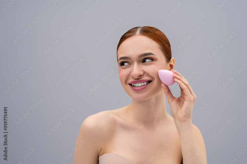 Pretty ginger caucasian woman using absorbing face sponge and smiling Pretty ginger caucasian woman using absorbing face sponge and smiling