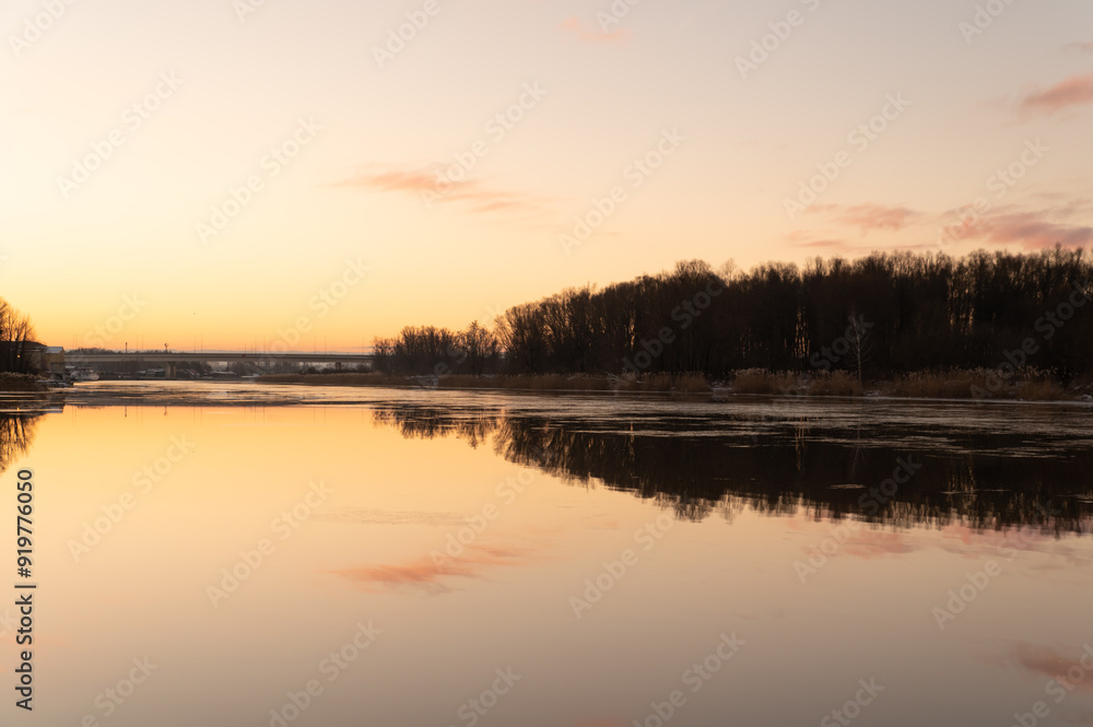 Yellow-pink sunrise on the bank of a winter river Yellow-pink sunrise on the bank of a winter river