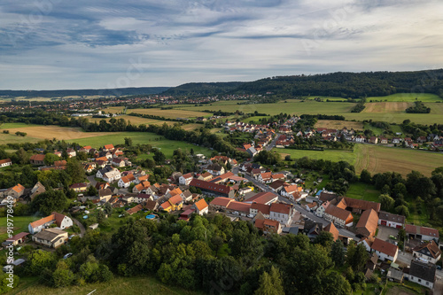 Obraz na płótnie Aer ial view of a German village surrounded by meadows, farmland and forest. Thuringia, Germany. w salonie