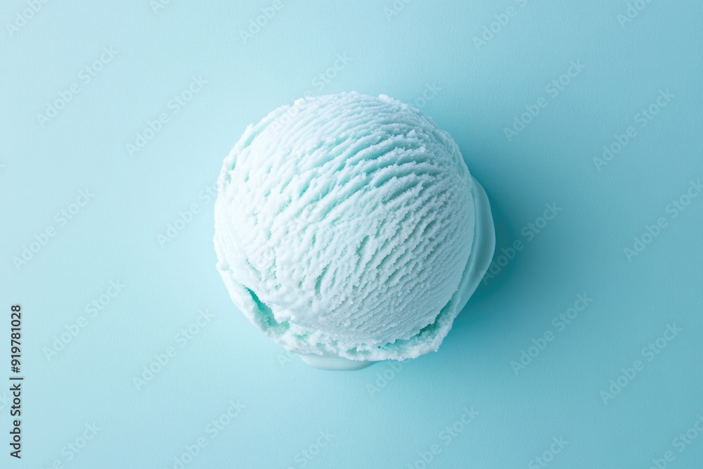 A top-down view of a light blue ice cream scoop on a light blue background. A top-down view of a light blue ice cream scoop on a light blue background.