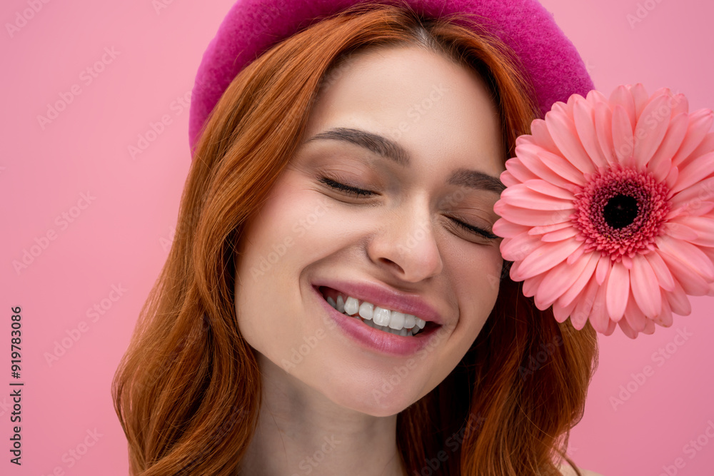 Smiling dreamy cute young woman with a flower Smiling dreamy cute young woman with a flower