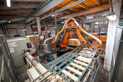 industrial robotic arm in a woodworking factory, highlighting advanced automation in wood processing and material handling photo