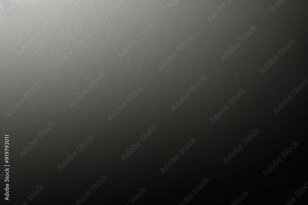 Black background made of real, shiny black paper covered with foil, illuminated by a soft light from above. Black background made of real, shiny black paper covered with foil, illuminated by a soft light from above.
