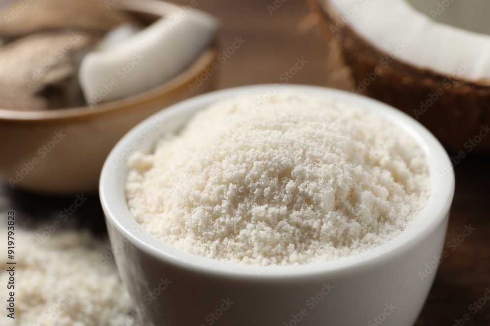 Organic coconut flour in bowl on table, closeup Organic coconut flour in bowl on table, closeup