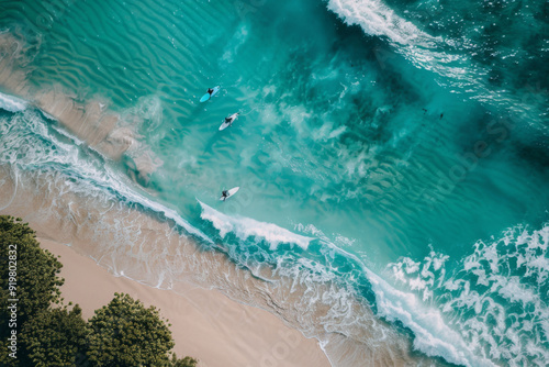 Tropical paradise beach with surfers aerial view