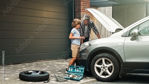фотографія Son and dad are standing and fixing auto engine demages in the yard