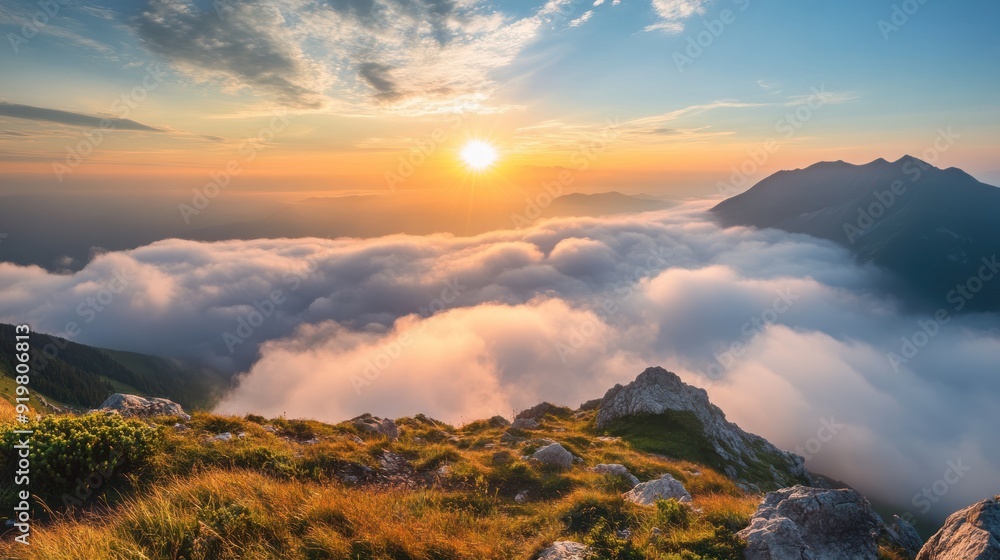 Obraz premium Majestic Sunrise Above the Clouds in Mountain Range - Breathtaking aerial view of a sunrise casting vibrant hues over a sea of clouds and distant mountain peaks. Perfect for nature lovers.