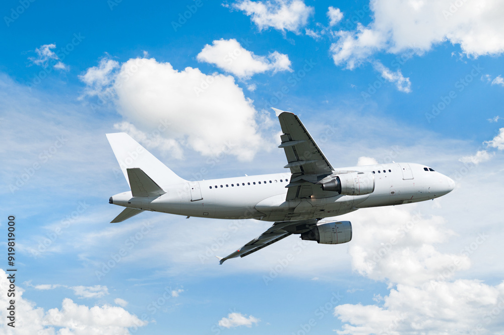 Obraz premium Airplane flying in the sky, travel background with commercial white flying airplane flying in the sky among dense white clouds