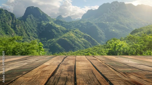 Wooden table with mountain and green nature background for placing ad products.