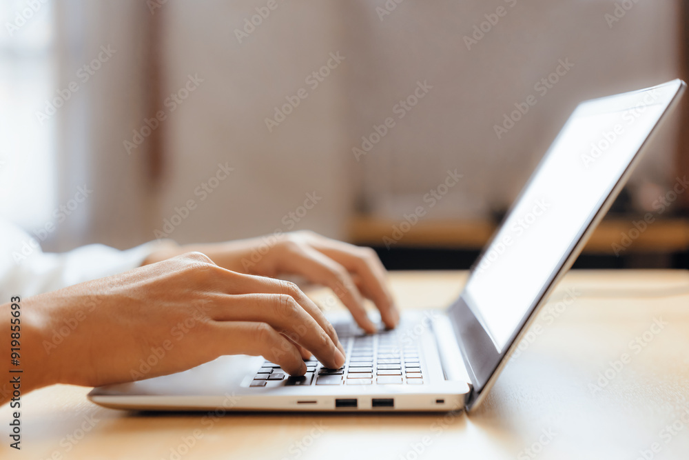 Businessman hand typing on computer keyboard of a laptop computer in office. Business and finance concept. uds Businessman hand typing on computer keyboard of a laptop computer in office. Business and finance concept. uds