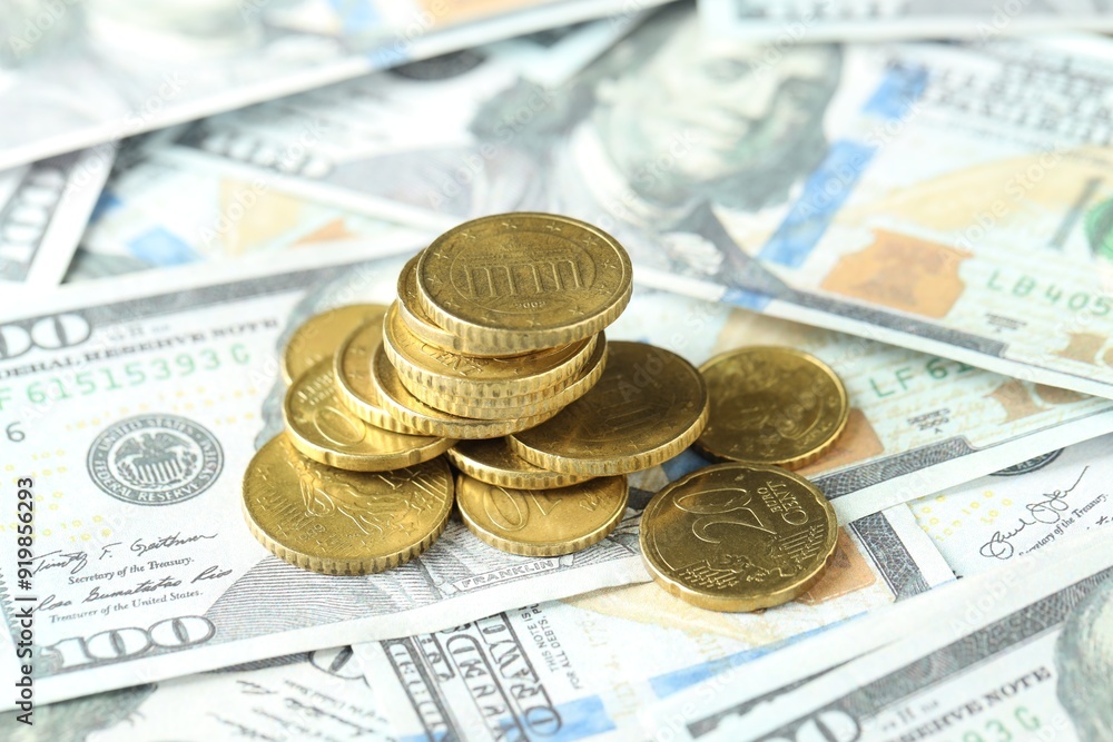 Many euro coins on dollar banknotes, closeup Many euro coins on dollar banknotes, closeup