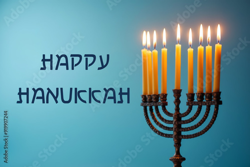 A menorah with nine lit candles, Hanukkah attribute. A text in English 'Happy Hanukkah' on blue background.
