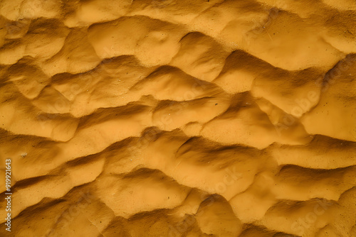 Golden Sand Dunes: A mesmerizing aerial view of undulating sand dunes in a desert landscape, bathed in warm sunlight. The rich ochre hues and intricate patterns create a sense of vastness and wonder. 