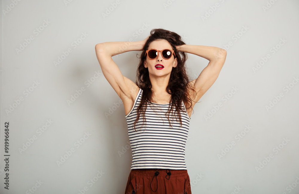 Fun relax smiling woman posing in fashion sunglasses and white t-shirt with red lipstick on white wall background with empty copy space. Happy lifestyle Fun relax smiling woman posing in fashion sunglasses and white t-shirt with red lipstick on white wall background with empty copy space. Happy lifestyle