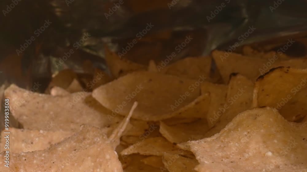 Close up of snacks scattered and contained in a package. Macro of snack placed with moving camera. Studio macro shot of potato chip with seasoning powder. Copy space for design and print. Pabulum. Close up of snacks scattered and contained in a package. Macro of snack placed with moving camera. Studio macro shot of potato chip with seasoning powder. Copy space for design and print. Pabulum.
