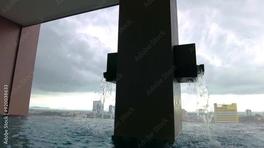 Low angle view of swimming pool fountain on high floor overlooking the city of Malacca. 4K slow-motion Low angle view of swimming pool fountain on high floor overlooking the city of Malacca. 4K slow-motion
