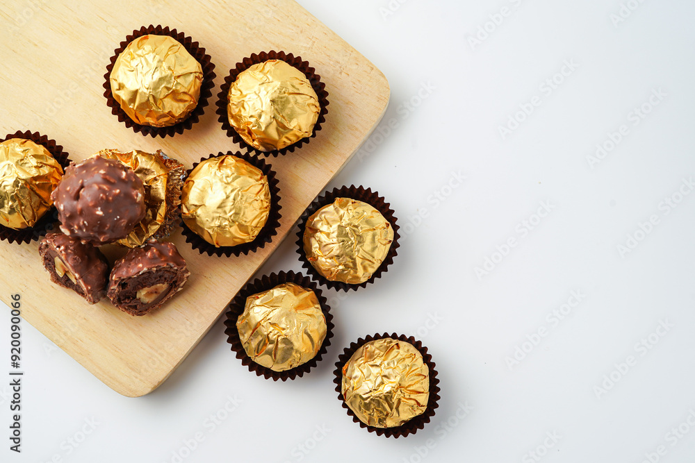 chocolate balls filled with hazelnuts, chocolate sweets in a gold wrapper chocolate balls filled with hazelnuts, chocolate sweets in a gold wrapper