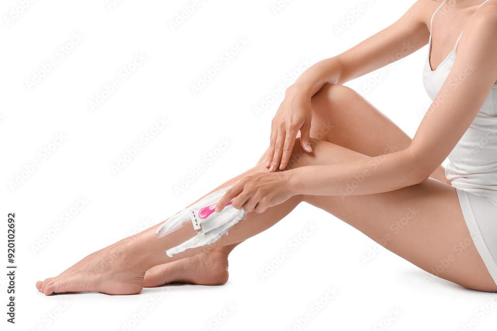 Woman shaving leg on white background, closeup Woman shaving leg on white background, closeup