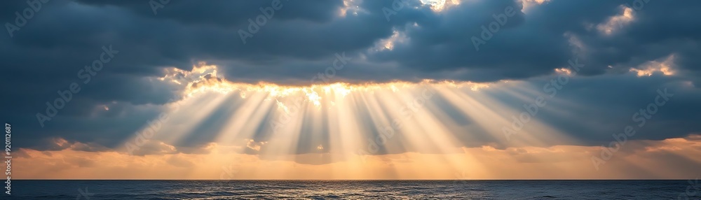 Golden Rays of Light Through Clouds Over Sea - Photo Golden Rays of Light Through Clouds Over Sea - Photo