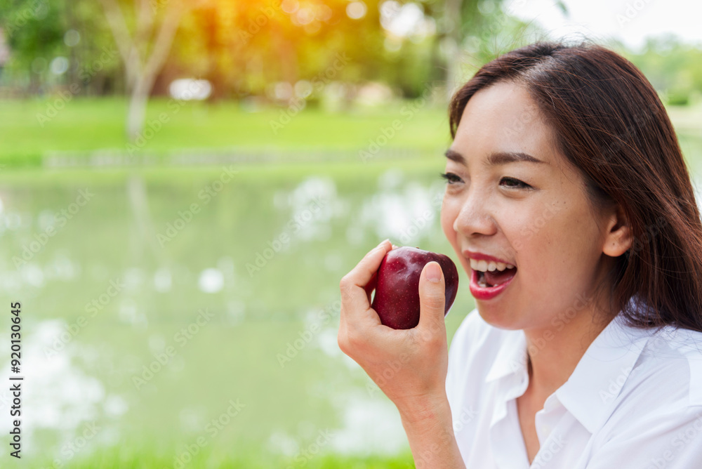 Young asian woman eating red Apple Healthy. Girl workout holding organic apple fruit healthy lifestyle. Wellness Asian women eat red apple smile face look at camera. Beauty health care lifestyle Young asian woman eating red Apple Healthy. Girl workout holding organic apple fruit healthy lifestyle. Wellness Asian women eat red apple smile face look at camera. Beauty health care lifestyle