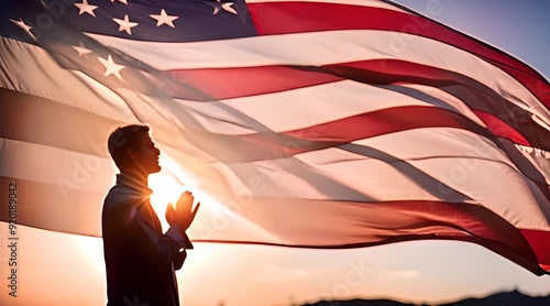 Praying Figure Silhouetted Against American Flag