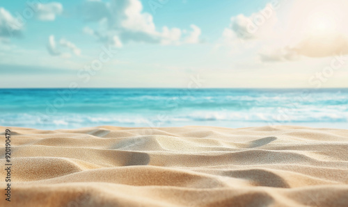 Beautiful summer background with a sandy beach and blue sky. Blurred empty space for product display, banner or design element. Summer vacation concept