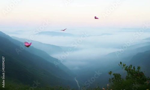 Pink Kites Over Misty Mountains: Three pink kites soar above a misty mountain valley at dawn, creating a serene and ethereal scene. The soft hues of the sky and the rolling hills evoke a sense of tran photo