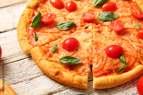 Tasty pizza margarita on white wooden background