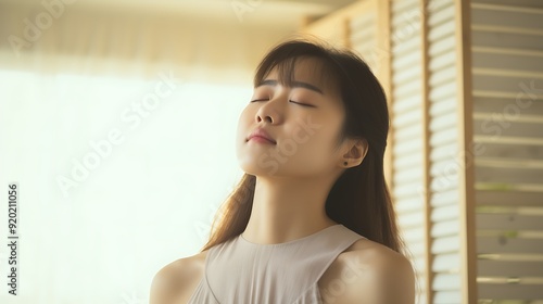Free Download Young Asian woman massaging neck pain at home - GFXLoad