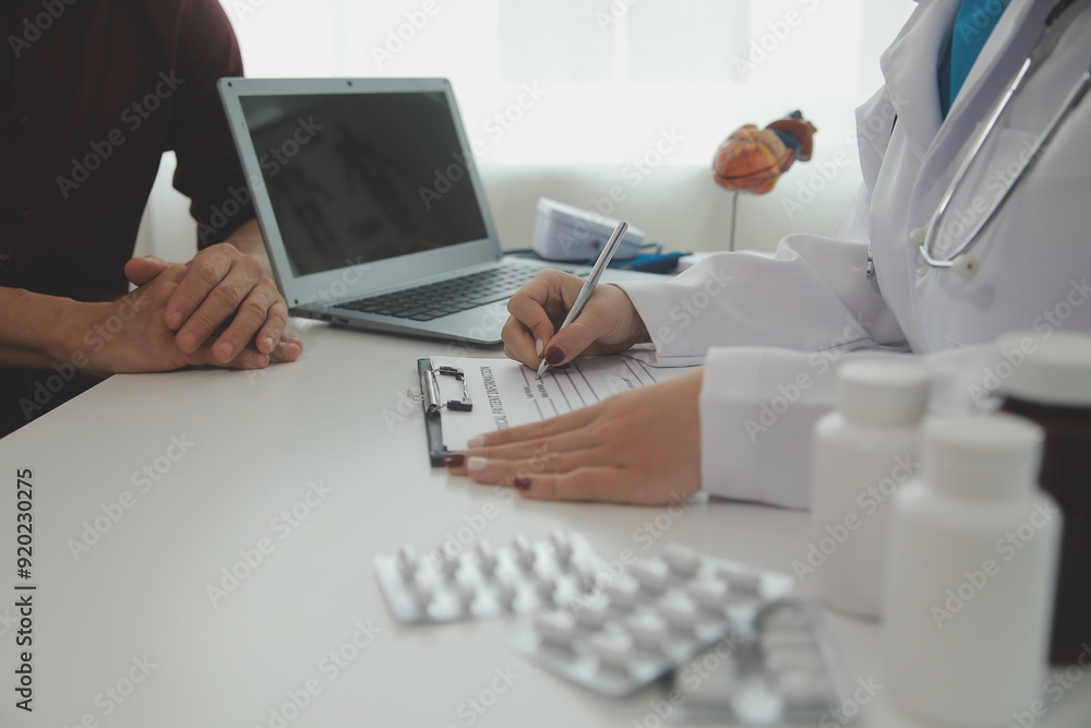 Fototapeta premium Doctor prescribing medicine giving pills to senior grandmother patient at hospital.