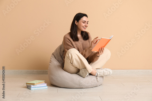 Young woman sitting on pouf...