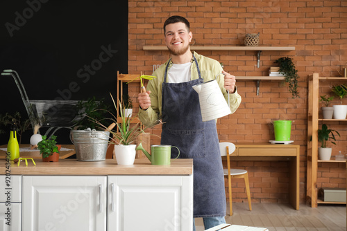 Young male gardener with wa...