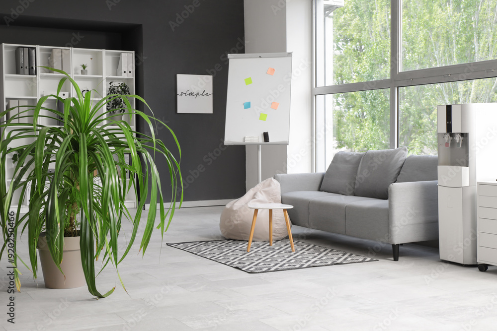 © Pixel-Shot - Interior of stylish office with sofa, houseplant and shelving unit © Pixel-Shot - Interior of stylish office with sofa, houseplant and shelving unit