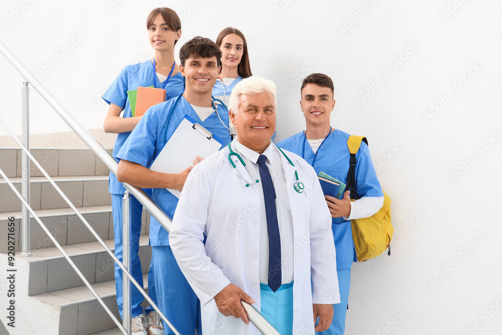 Group of medical students with doctor on stairs at university Group of medical students with doctor on stairs at university