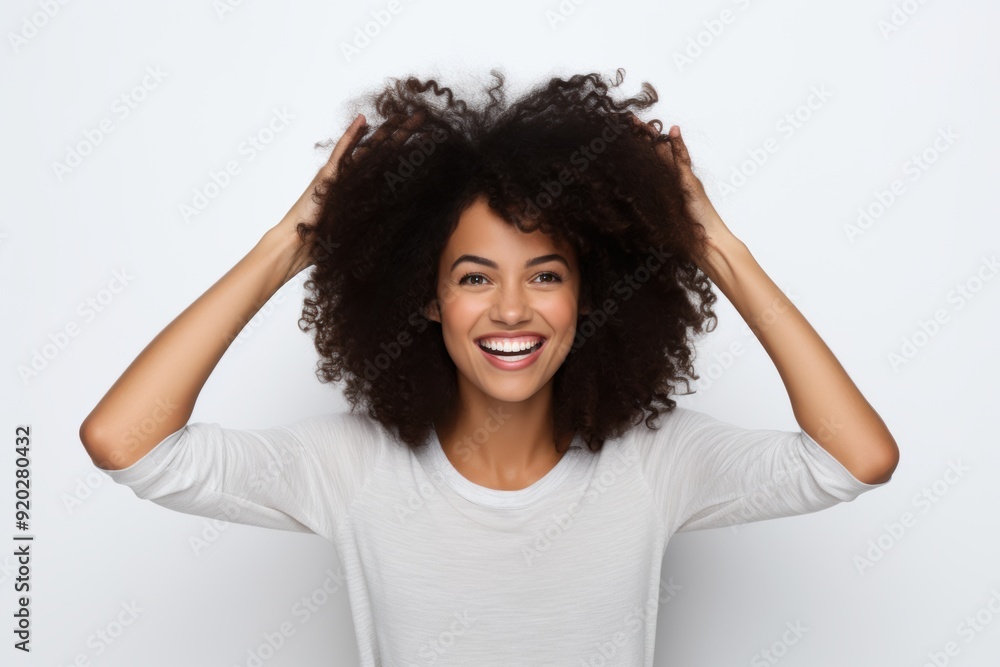woman with voluminous curly hair smiles confidently while styling her hair, radiating positivity and self-assurance woman with voluminous curly hair smiles confidently while styling her hair, radiating positivity and self-assurance