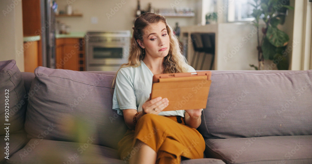 Couch, freelancer or woman with tablet for reading, information and online article of local news. Remote work, female designer and digital at home for research, hmm reaction and scroll in website Couch, freelancer or woman with tablet for reading, information and online article of local news. Remote work, female designer and digital at home for research, hmm reaction and scroll in website
