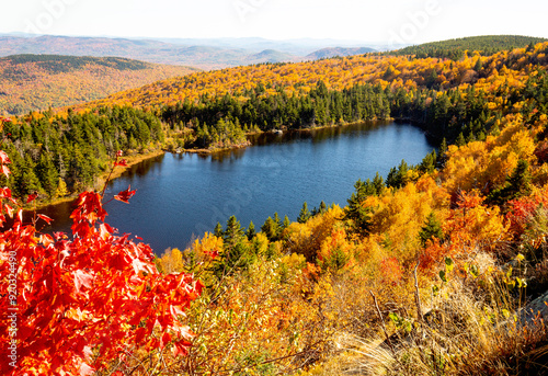 Fall foliage colors surrounding Lake Solitude in Newbury, New Hampshire.