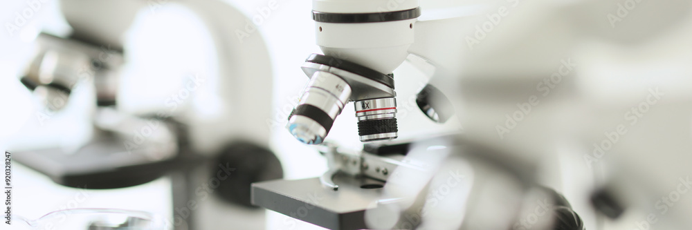 White microscopes standing in row in laboratory White microscopes standing in row in laboratory