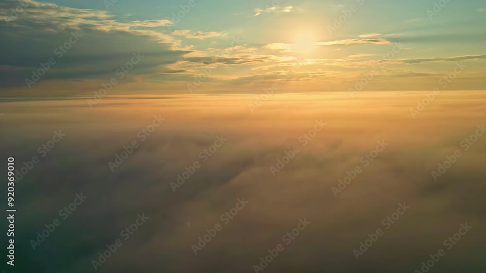 Beautiful landscape of a sunset with the sun's rays on the clouds in an aerial shot Beautiful landscape of a sunset with the sun's rays on the clouds in an aerial shot