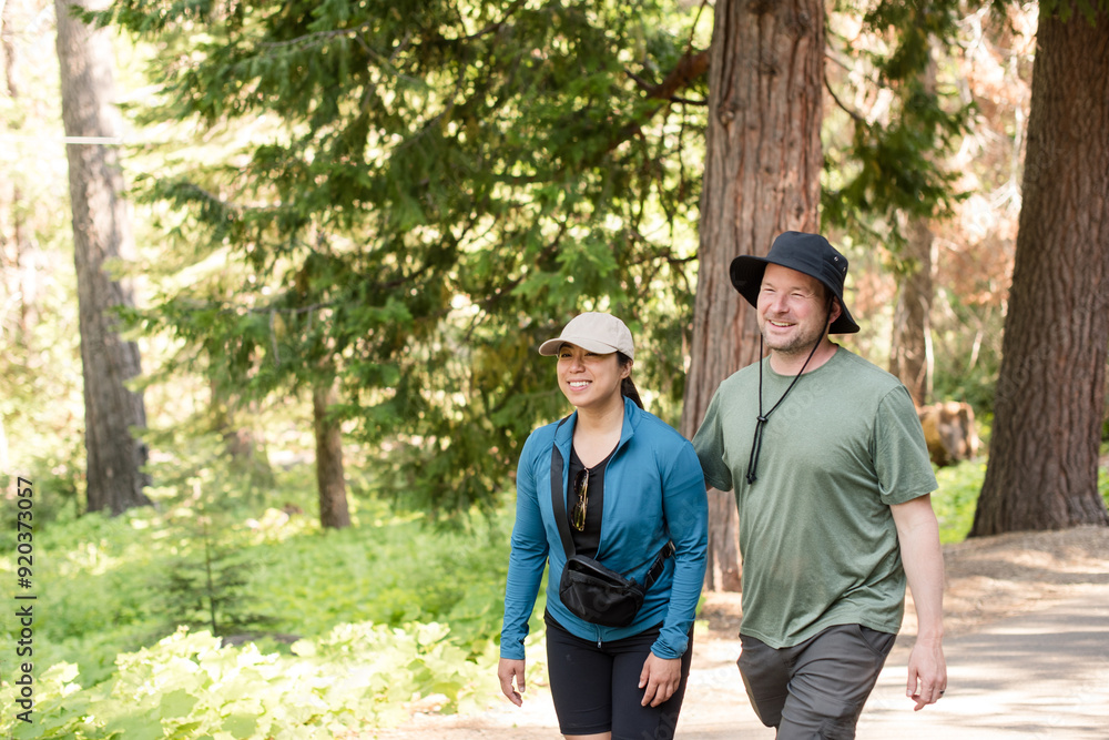 Couple laughing together while walking outdoors Couple laughing together while walking outdoors
