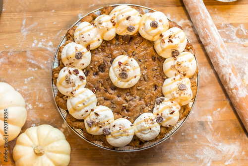 Chocolate chip cookie pie topped with whipped cream and chooclat photo