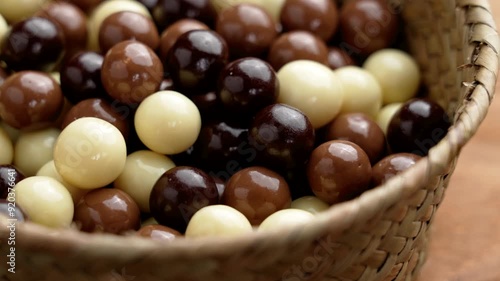 Wallpaper Mural Various chocolate ball candies in rustic wicker bowl on brown board. Delicate treats. Rotation Torontodigital.ca
